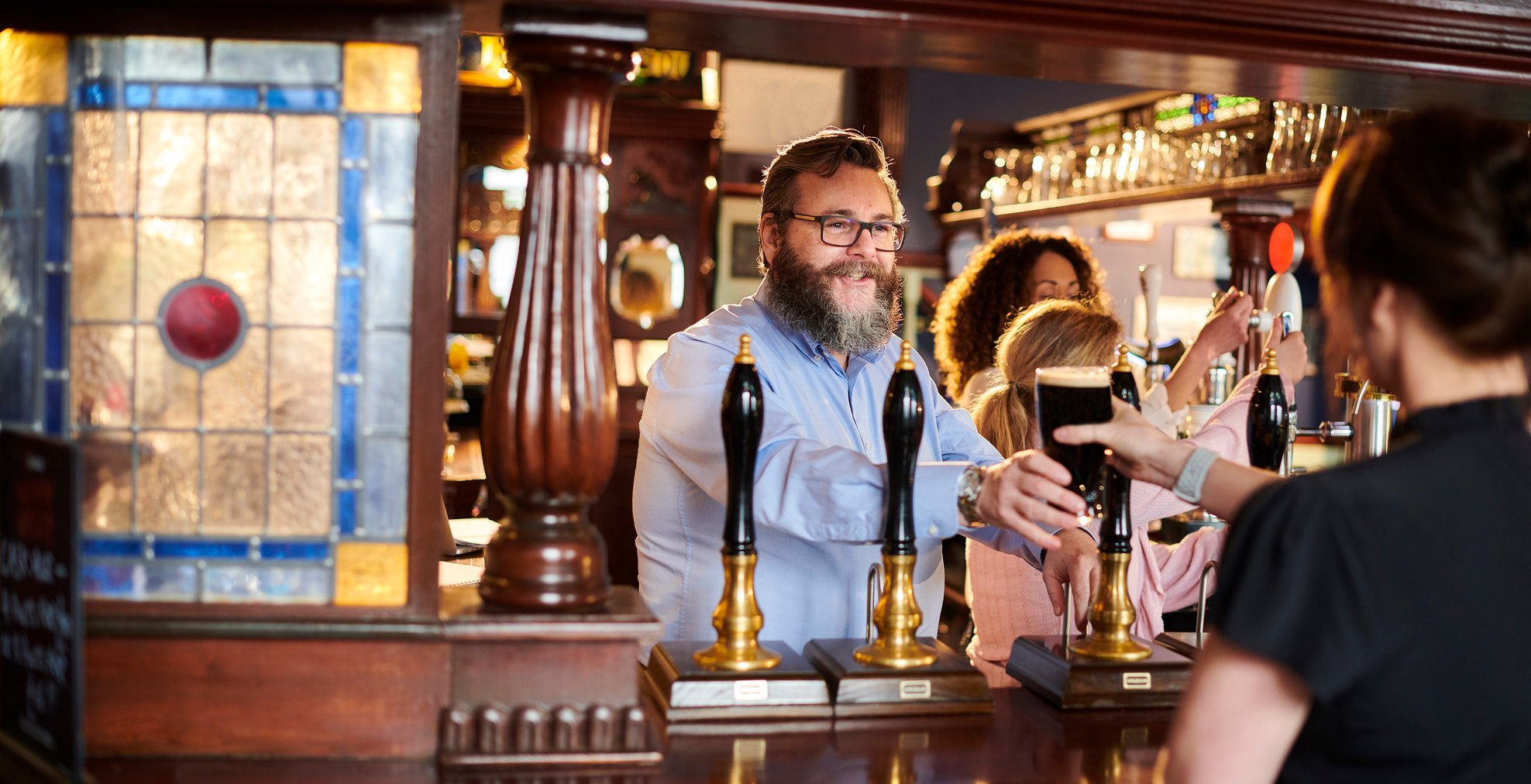 pub landlord welcoming customer