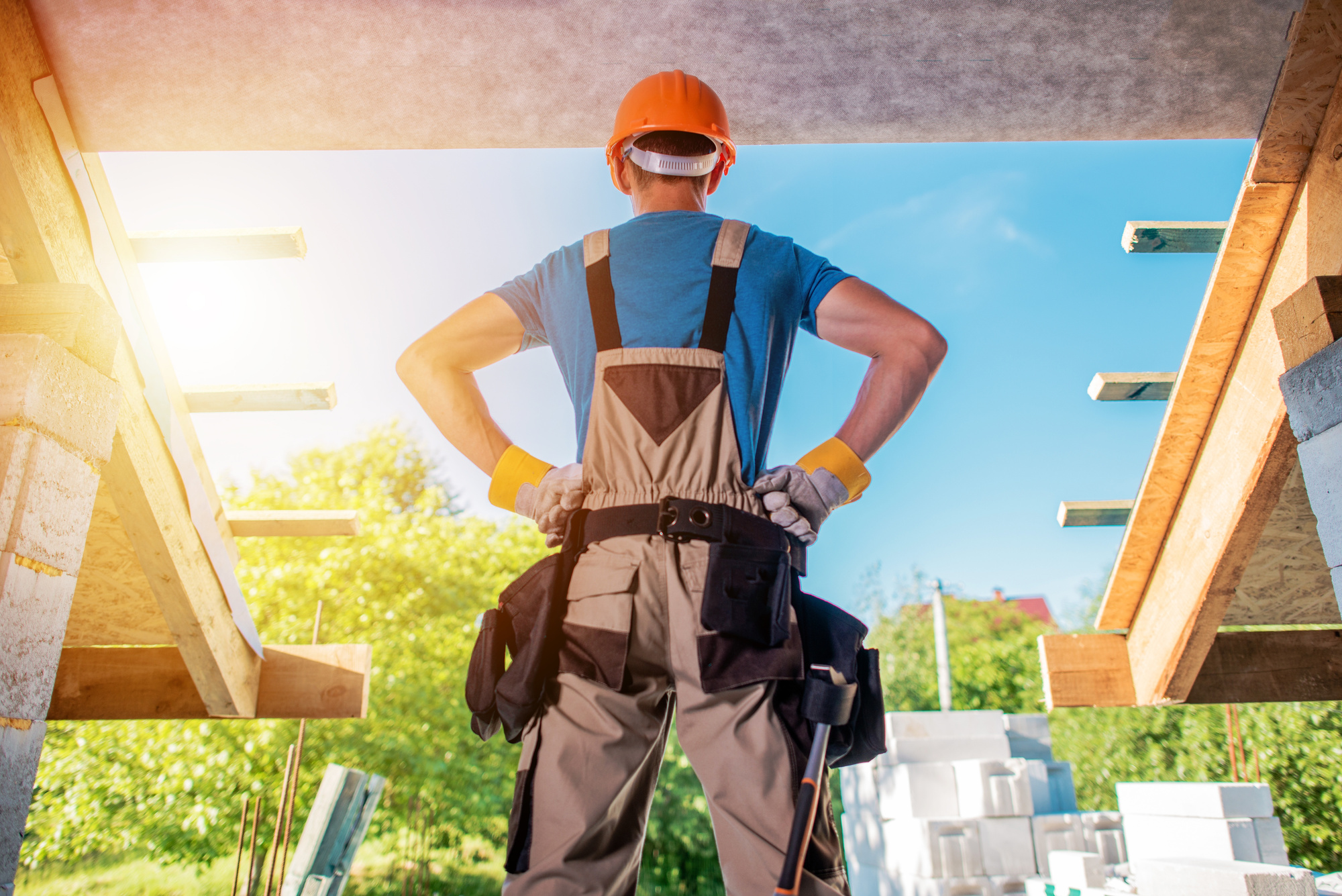 New House Building Project with a Man on Hardhat Posing